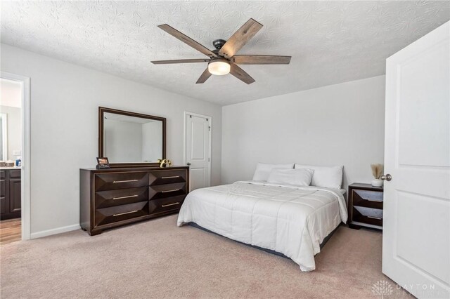 1918 Bessie Ave, Moraine, OH 45439 - bedroom with light colored carpet, a textured ceiling, a ceiling fan, and ensuite bath