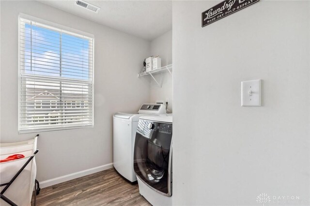 1918 Bessie Ave, Moraine, OH 45439 - laundry room featuring washer and clothes dryer, wood finished floors, and healthy amount of natural light