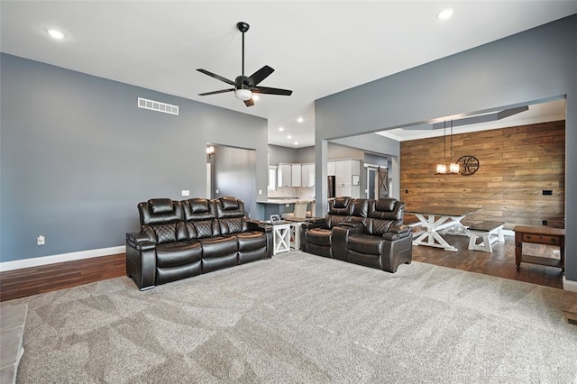 1584 Heritage Run Dr, Lebanon, OH 45036 - living room featuring wood walls, a ceiling fan, recessed lighting, wood finished floors, and carpet floors