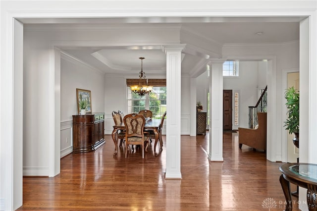 4738 Saddletop Ridge Ln, Mason, OH 45040 - dining area with decorative columns, wood finished floors, a chandelier, a decorative wall, and ornamental molding