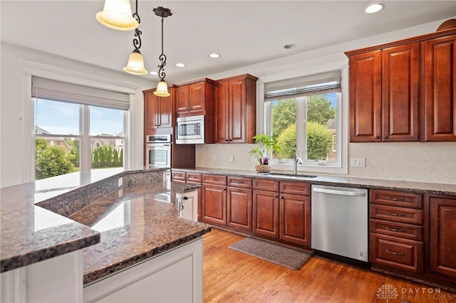 4738 Saddletop Ridge Ln, Mason, OH 45040 - kitchen with stainless steel appliances, pendant lighting, recessed lighting, decorative backsplash, and stone countertops