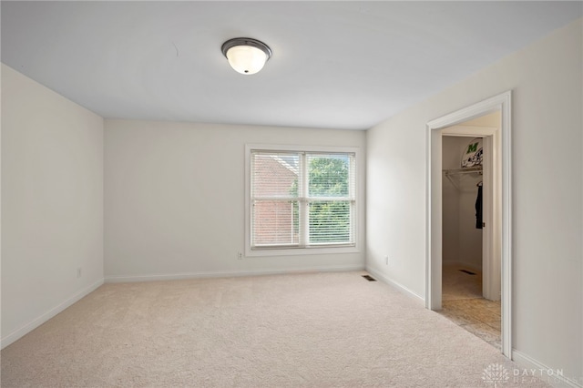 4738 Saddletop Ridge Ln, Mason, OH 45040 - unfurnished bedroom with light carpet, a walk in closet, and a closet