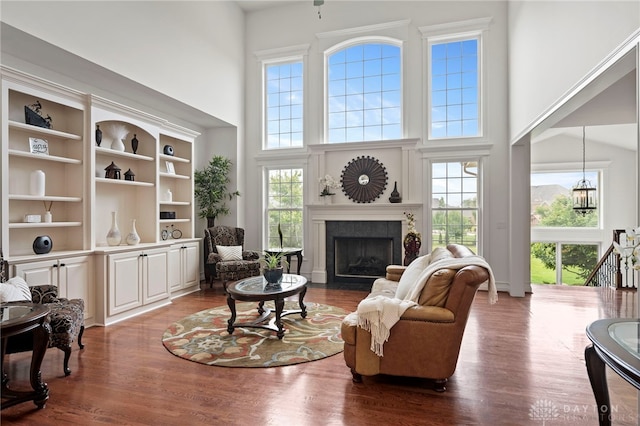 4738 Saddletop Ridge Ln, Mason, OH 45040 - living room featuring a high ceiling, a tile fireplace, and dark wood-style flooring