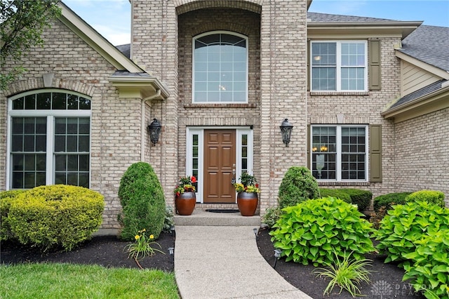 4738 Saddletop Ridge Ln, Mason, OH 45040 - view of exterior entry featuring brick siding, roof with shingles, and a chimney