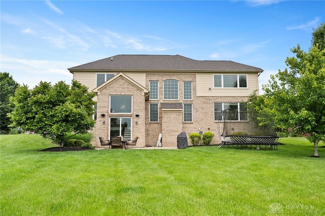 4738 Saddletop Ridge Ln, Mason, OH 45040 - back of house featuring a lawn, a patio, and brick siding