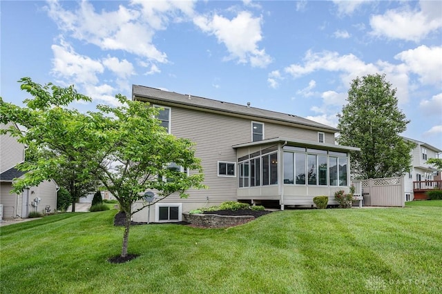4395 Turtledove Way, Miamisburg, OH 45342 - rear view of house with a sunroom and a lawn