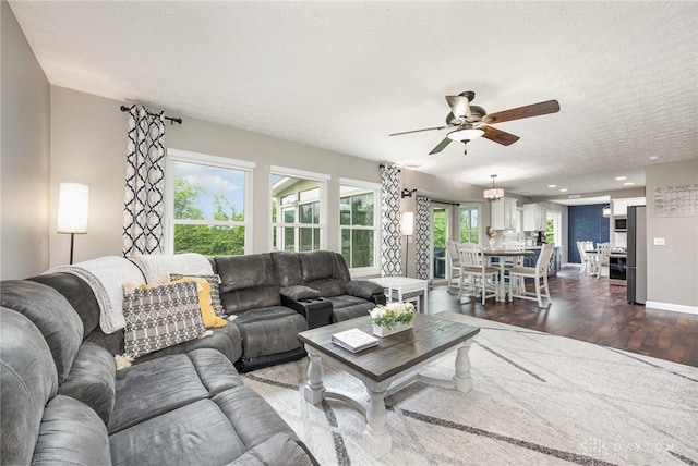 4395 Turtledove Way, Miamisburg, OH 45342 - living room featuring dark wood-style floors, a ceiling fan, a textured ceiling, healthy amount of natural light, and recessed lighting