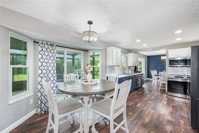 4395 Turtledove Way, Miamisburg, OH 45342 - dining space featuring healthy amount of natural light, a textured ceiling, dark wood-style flooring, a chandelier, and recessed lighting