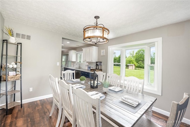4395 Turtledove Way, Miamisburg, OH 45342 - dining room with a chandelier, dark wood-style floors, and a textured ceiling