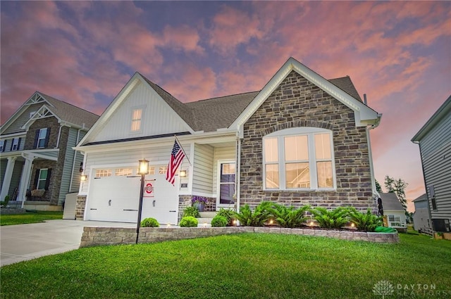 181 Cresting Rd, Fairborn, OH 45324 - view of front facade with stone siding, concrete driveway, a yard, and an attached garage