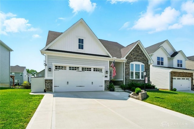 181 Cresting Rd, Fairborn, OH 45324 - craftsman inspired home with stone siding, a front yard, driveway, and board and batten siding