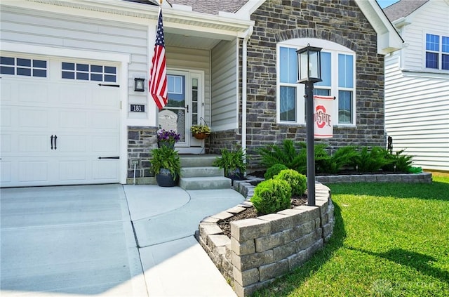 181 Cresting Rd, Fairborn, OH 45324 - doorway to property with stone siding, a yard, a garage, and driveway