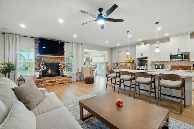 181 Cresting Rd, Fairborn, OH 45324 - living room featuring a fireplace, healthy amount of natural light, light wood finished floors, recessed lighting, and a ceiling fan