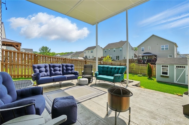181 Cresting Rd, Fairborn, OH 45324 - fenced backyard featuring an outdoor living space with a fire pit, a residential view, a patio area, and a storage unit