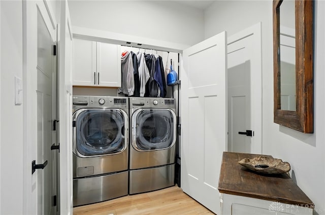 181 Cresting Rd, Fairborn, OH 45324 - washroom featuring cabinet space, washer and clothes dryer, and light wood-style floors