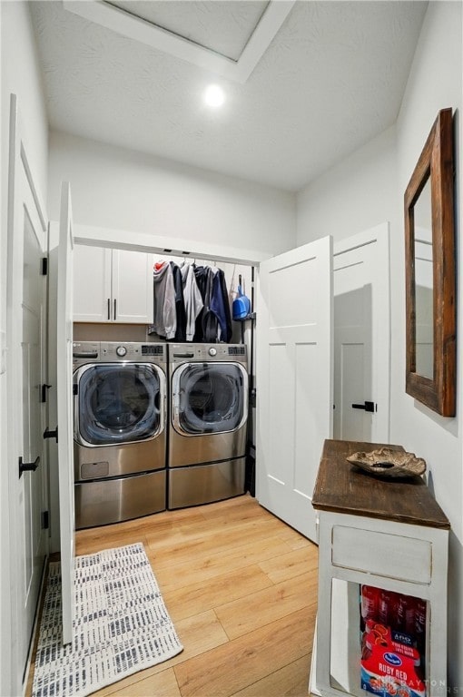 181 Cresting Rd, Fairborn, OH 45324 - laundry area featuring washing machine and clothes dryer, cabinet space, light wood-style floors, and recessed lighting