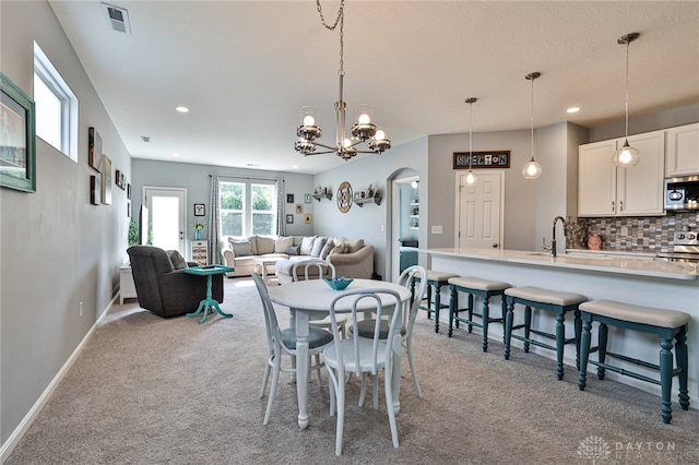928 Southline Dr, Lebanon, OH 45036 - dining room featuring light colored carpet, arched walkways, recessed lighting, and a chandelier