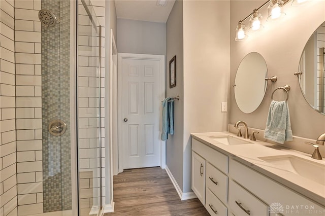 928 Southline Dr, Lebanon, OH 45036 - bathroom featuring double vanity, tiled shower, and wood finished floors
