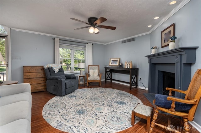 2823 Red Lion Ct, Centerville, OH 45440 - living room featuring ornamental molding, a fireplace with raised hearth, ceiling fan, wood finished floors, and recessed lighting