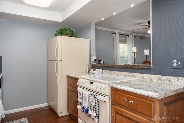 2823 Red Lion Ct, Centerville, OH 45440 - kitchen with white appliances, brown cabinetry, ceiling fan, dark wood-type flooring, and crown molding