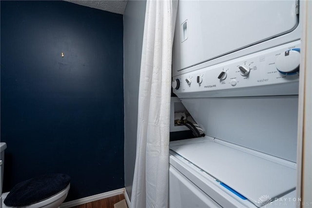 2823 Red Lion Ct, Centerville, OH 45440 - washroom with stacked washer and clothes dryer and wood finished floors