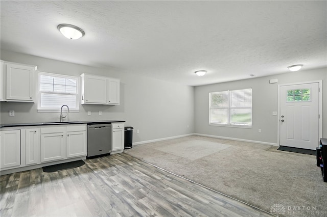 720 Diamond Loop, Middletown, OH 45044 - kitchen featuring stainless steel dishwasher, dark countertops, white cabinets, plenty of natural light, and a textured ceiling