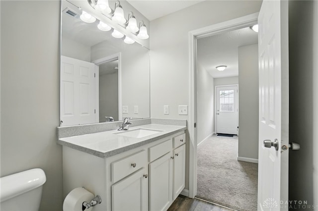 720 Diamond Loop, Middletown, OH 45044 - half bathroom featuring vanity and wood finished floors