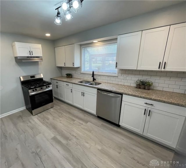 1601 Forrer Blvd, Kettering, OH 45420 - kitchen featuring stainless steel appliances, backsplash, white cabinets, light wood finished floors, and stone countertops