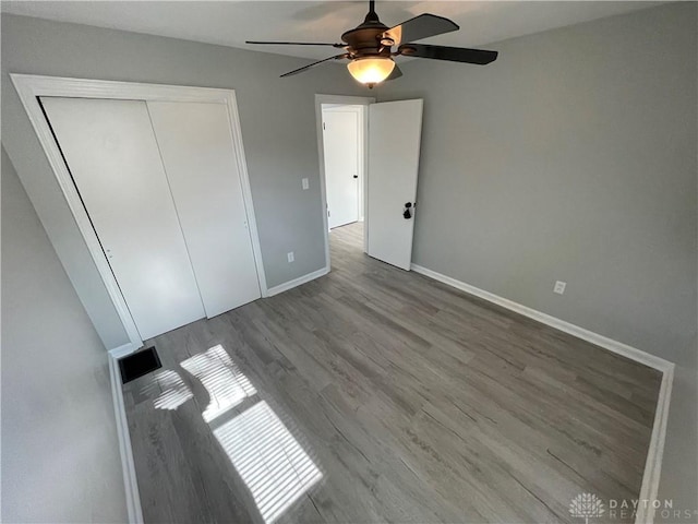 1601 Forrer Blvd, Kettering, OH 45420 - unfurnished bedroom with wood finished floors, a closet, and a ceiling fan
