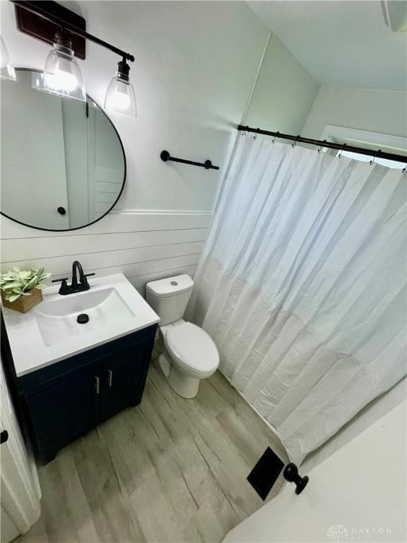 1601 Forrer Blvd, Kettering, OH 45420 - full bath with vanity, wood finished floors, a wainscoted wall, and a shower with shower curtain