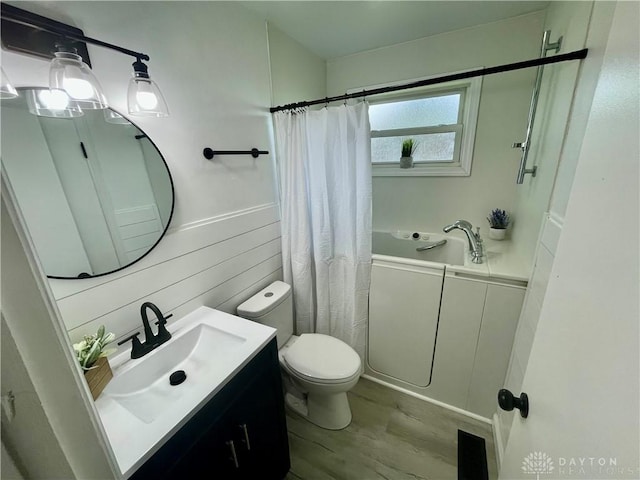 1601 Forrer Blvd, Kettering, OH 45420 - full bath with vanity, wood finished floors, a tub to relax in, wooden walls, and wainscoting