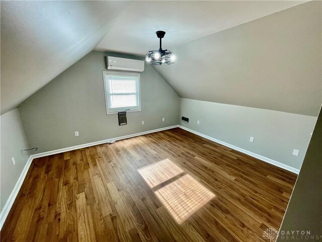 1601 Forrer Blvd, Kettering, OH 45420 - bonus room featuring an AC wall unit, wood finished floors, and lofted ceiling