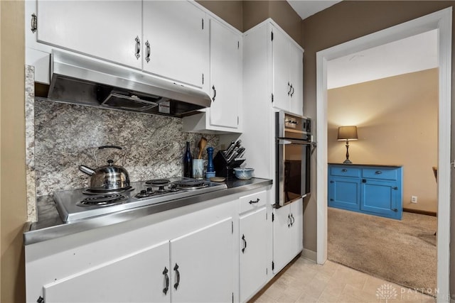 3611 Delaine Ave, Kettering, OH 45429 - kitchen with under cabinet range hood, wall oven, stainless steel electric stovetop, decorative backsplash, and white cabinets
