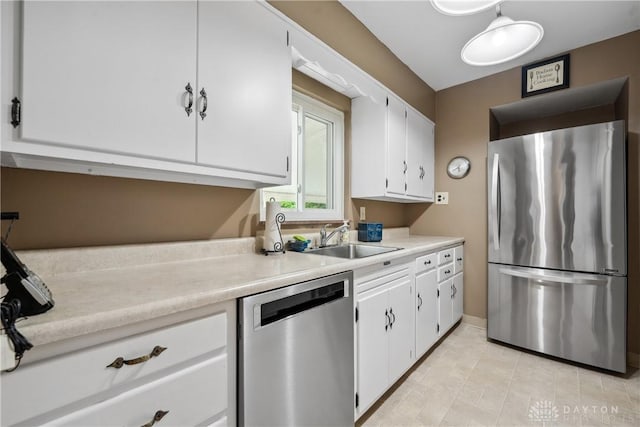 3611 Delaine Ave, Kettering, OH 45429 - kitchen featuring stainless steel appliances, light countertops, white cabinets, and light tile patterned floors