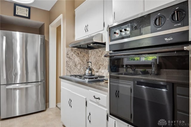 3611 Delaine Ave, Kettering, OH 45429 - kitchen featuring stainless steel appliances, under cabinet range hood, backsplash, and white cabinets