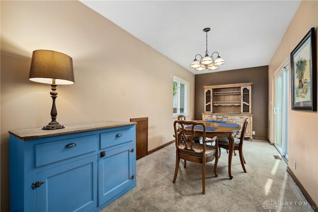 3611 Delaine Ave, Kettering, OH 45429 - dining space with light colored carpet and a chandelier