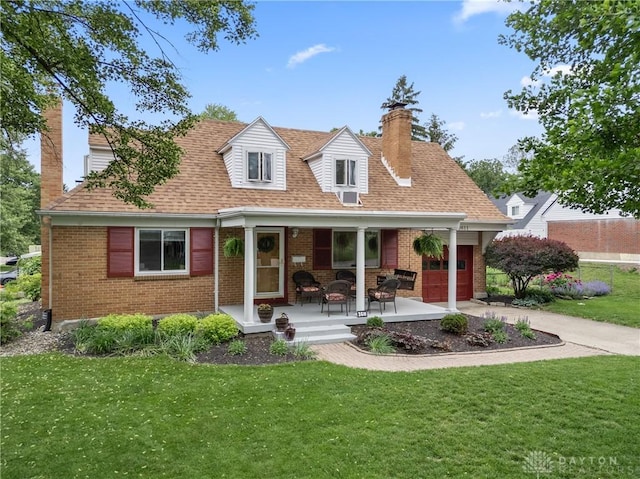 3611 Delaine Ave, Kettering, OH 45429 - back of property with a chimney, a porch, brick siding, and an attached garage