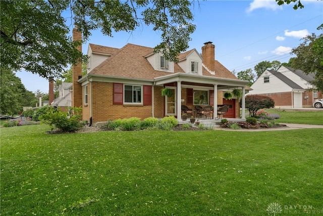 3611 Delaine Ave, Kettering, OH 45429 - view of front facade with a chimney, brick siding, a front lawn, and roof with shingles
