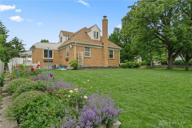 3611 Delaine Ave, Kettering, OH 45429 - rear view of house with brick siding and a chimney