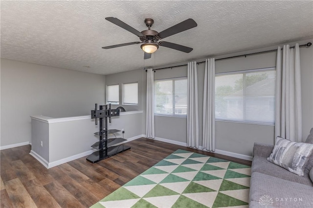 1107 Sunset Dr, Englewood, OH 45322 - living area featuring wood finished floors, a ceiling fan, and a textured ceiling