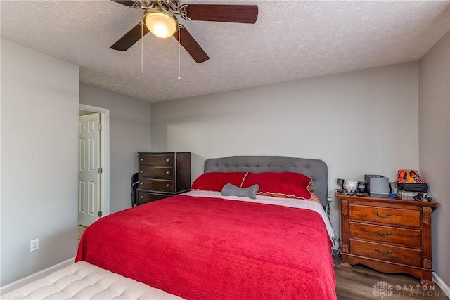 1107 Sunset Dr, Englewood, OH 45322 - bedroom with wood finished floors, a ceiling fan, and a textured ceiling