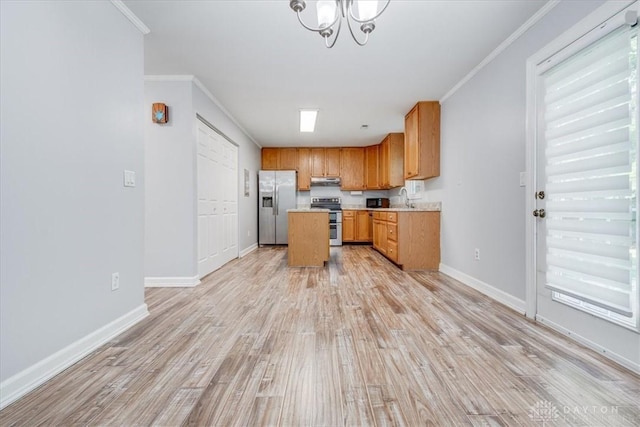 113 Village Trail Dr Unit 6, Vandalia, OH 45377 - kitchen featuring appliances with stainless steel finishes, light countertops, under cabinet range hood, light wood-style flooring, and crown molding