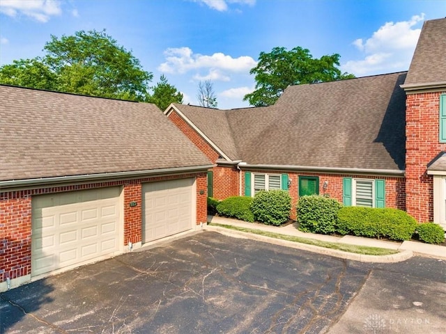 113 Village Trail Dr Unit 6, Vandalia, OH 45377 - view of front of home with brick siding, a shingled roof, asphalt driveway, and an attached garage