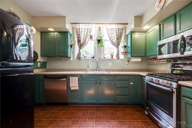18 E Washington St, Jamestown Vlg, OH 45335 - kitchen featuring stainless steel appliances, green cabinets, light countertops, and dark tile patterned flooring