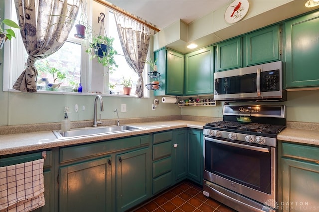 18 E Washington St, Jamestown Vlg, OH 45335 - kitchen featuring appliances with stainless steel finishes, light countertops, dark tile patterned flooring, and green cabinets
