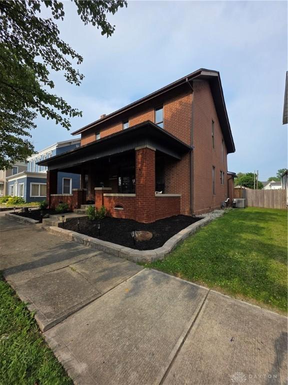 126 S Maple St, Eaton, OH 45320 - view of side of home with brick siding and a central air condition unit