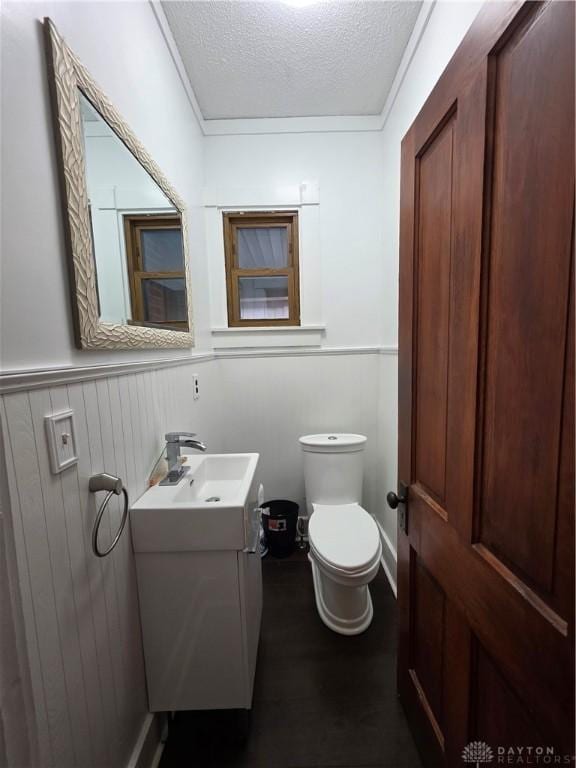 126 S Maple St, Eaton, OH 45320 - half bathroom with vanity, a textured ceiling, and a wainscoted wall