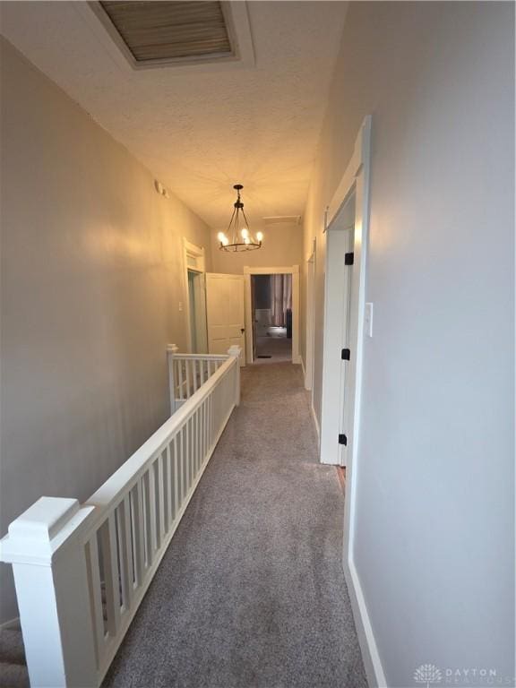 126 S Maple St, Eaton, OH 45320 - hallway featuring an upstairs landing, carpet flooring, a chandelier, and a textured ceiling