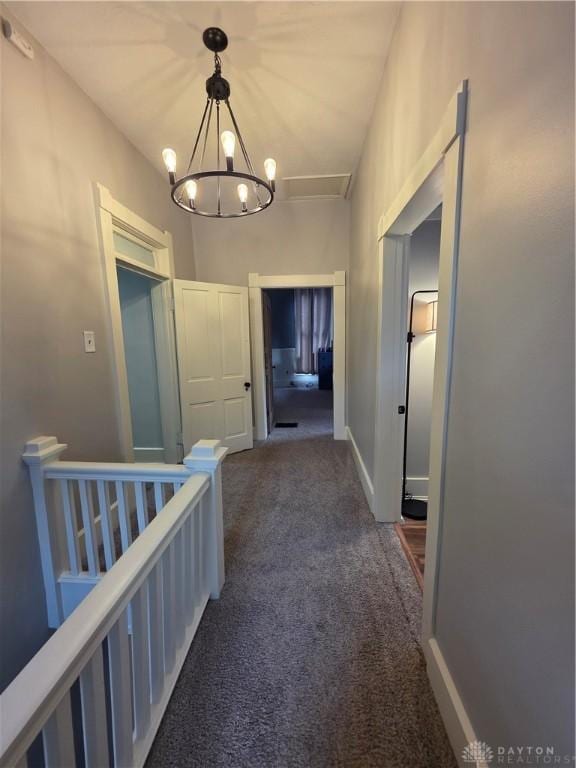 126 S Maple St, Eaton, OH 45320 - corridor with carpet floors, an upstairs landing, and a chandelier
