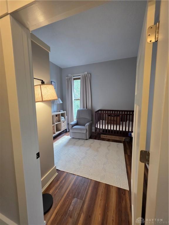 126 S Maple St, Eaton, OH 45320 - bedroom with wood finished floors, a nursery area, and lofted ceiling